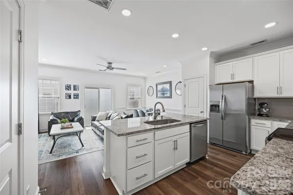 a kitchen with a sink appliances and cabinets