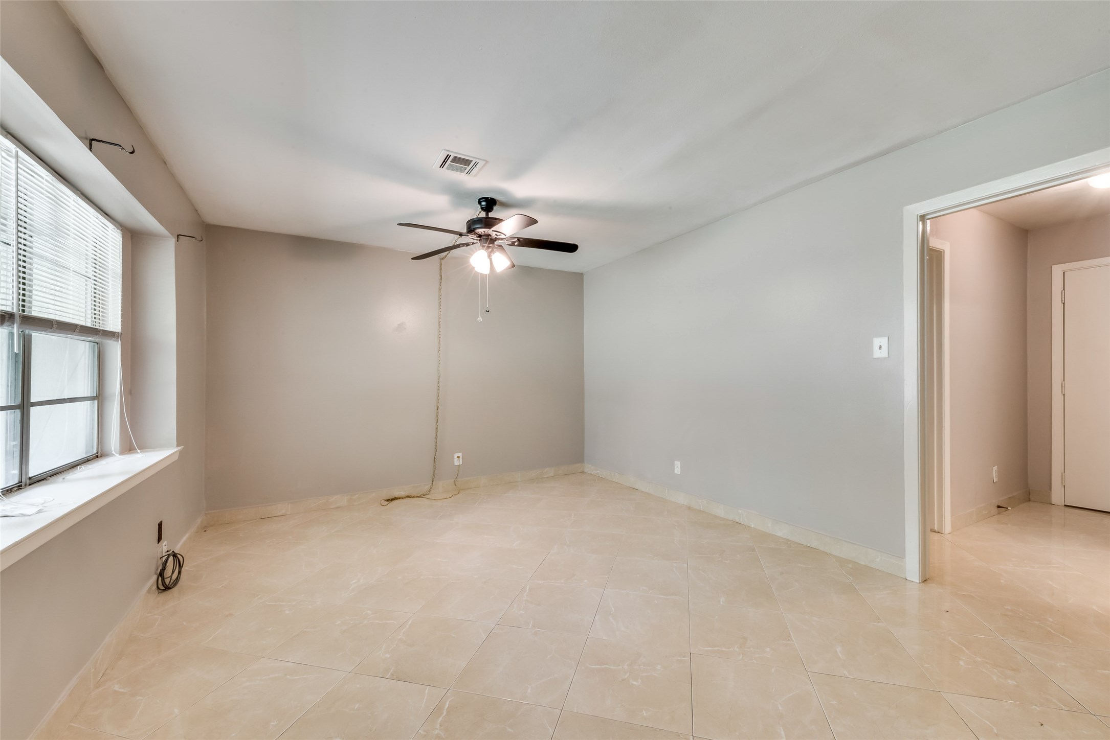 1522 Baggett Lane, Unit A Houston, TX 77055 - Photo 1 of 29 an empty room with chandelier fan and windows