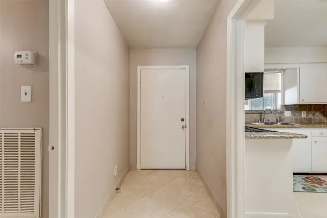 a view of a kitchen with white cabinets