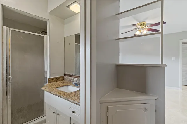 a bathroom with a granite countertop sink a toilet and a mirror