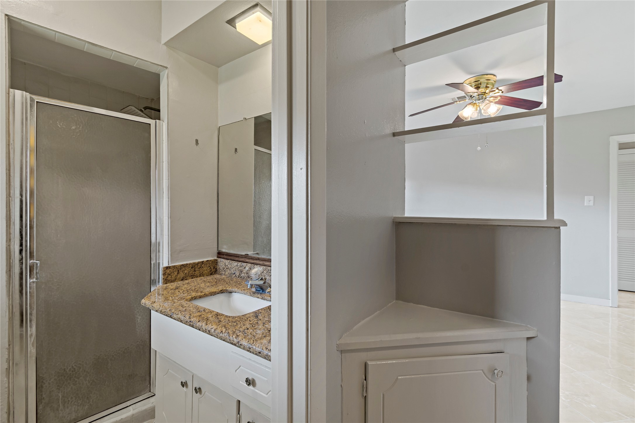1522 Baggett Lane, Unit A Houston, TX 77055 - Photo 22 of 29 a bathroom with a granite countertop sink a toilet and a mirror