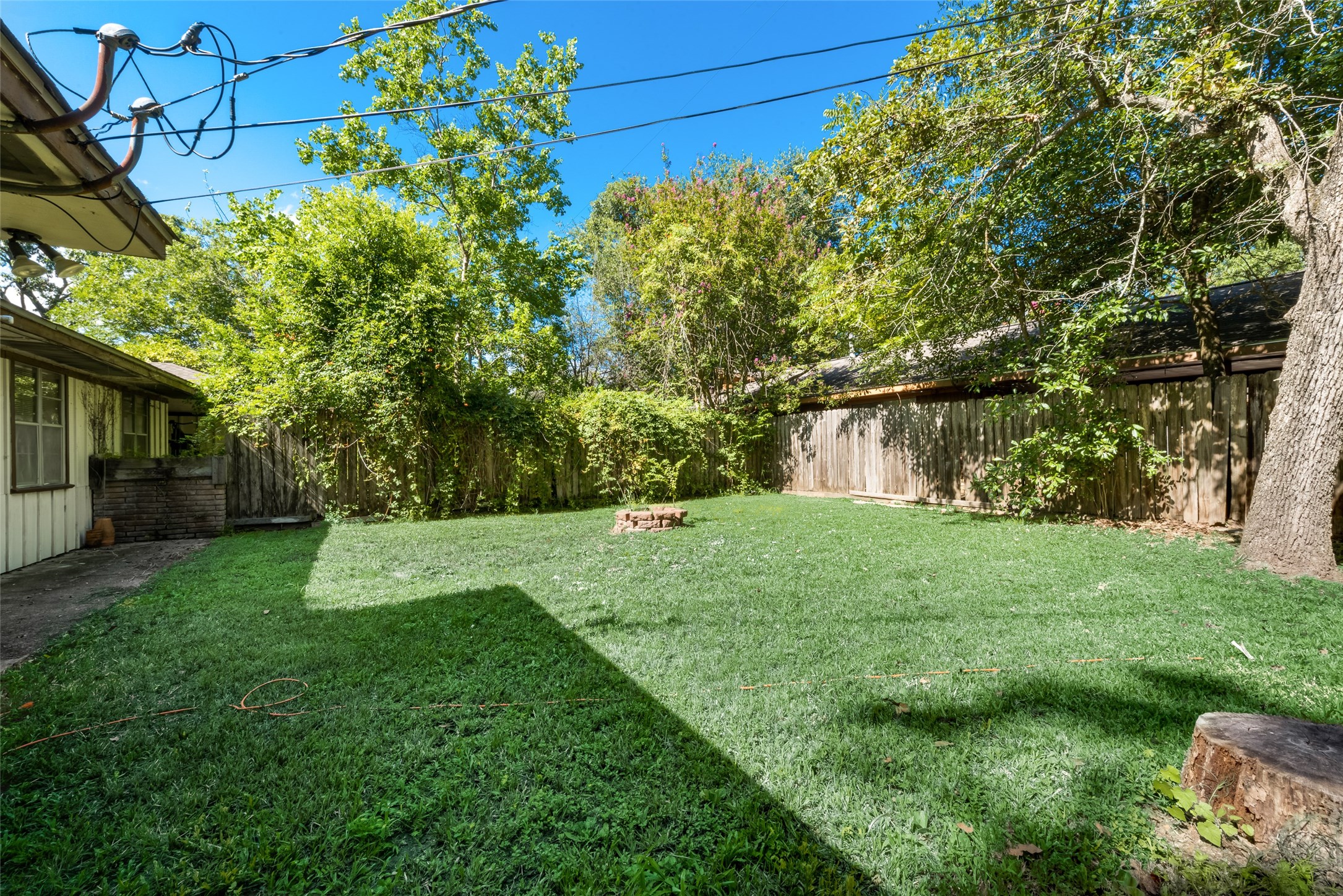 1522 Baggett Lane, Unit A Houston, TX 77055 - Photo 24 of 29 a view of a backyard with table and chairs and a large tree