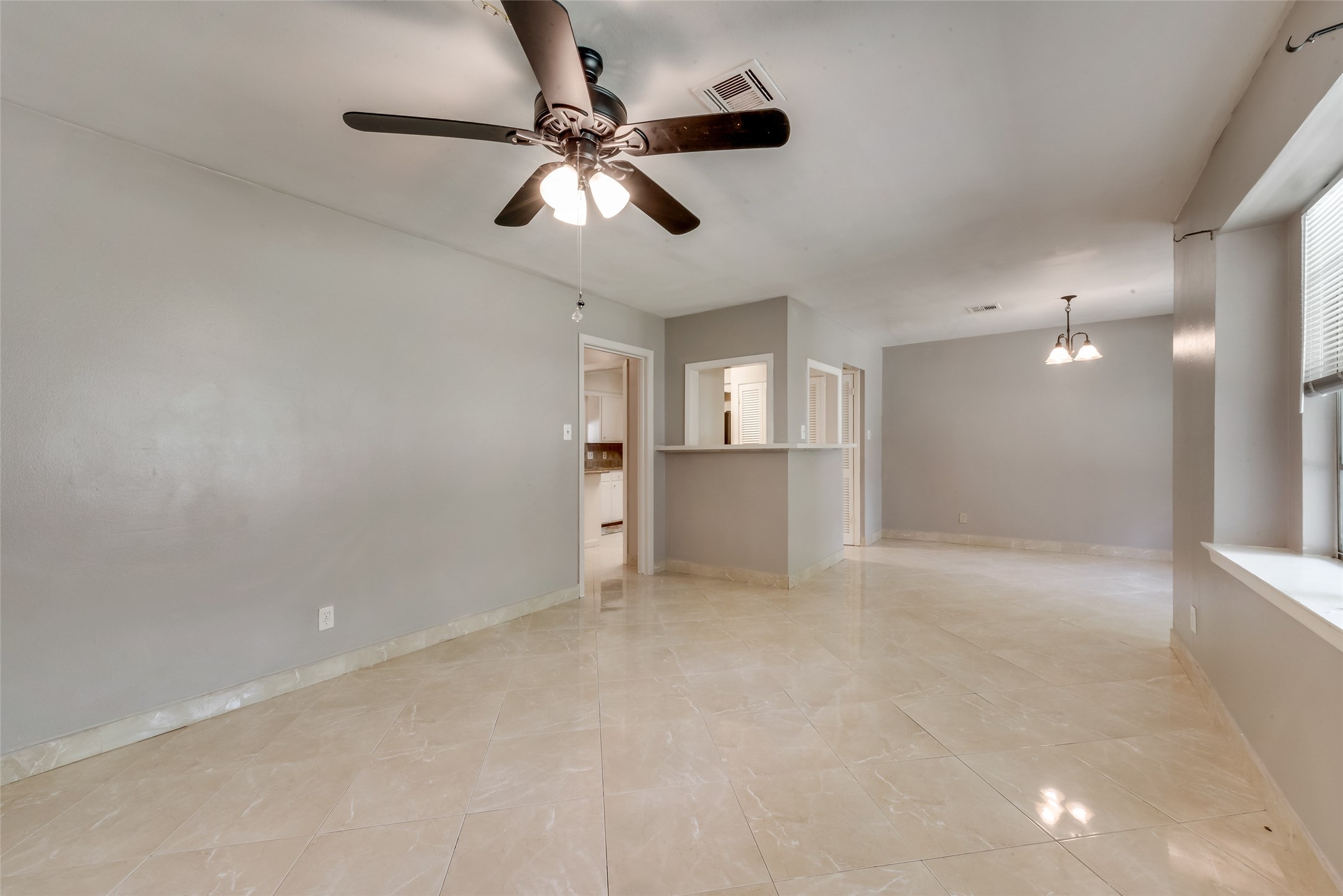 1522 Baggett Lane, Unit A Houston, TX 77055 - Photo 3 of 29 an empty room with chandelier fan and windows