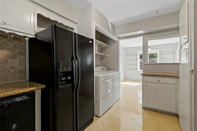 a kitchen with a refrigerator and cabinets
