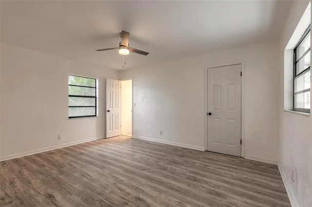 wooden floor in an empty room with a window