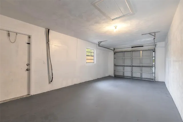 an empty room with closet and windows