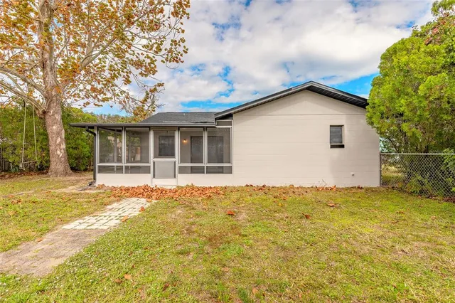 a view of a house with a yard and potted plants