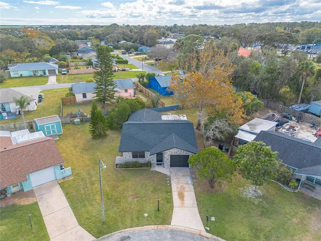 an aerial view of residential houses with outdoor space