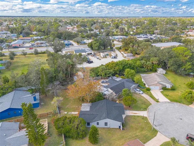 an aerial view of residential houses with outdoor space