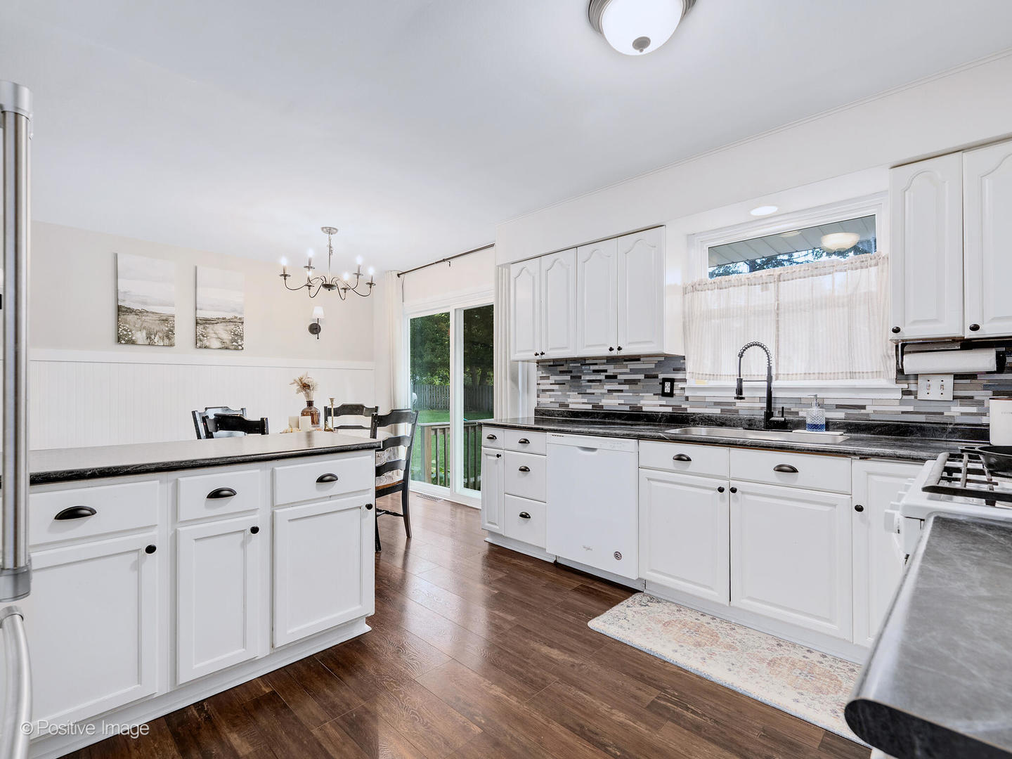 2 Sunset Lane Algonquin, IL 60102 - Photo 8 of 18 a kitchen with granite countertop white cabinets and white appliances