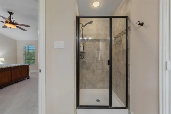 a bathroom with a glass shower door