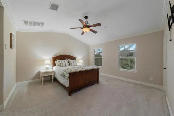a spacious bedroom with a bed and window