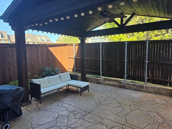 a backyard of a house with table and chairs