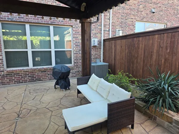 a view of a patio with table and chairs and potted plants