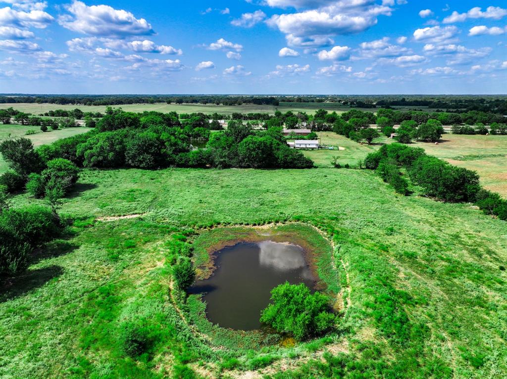 7801 West Interstate Highway Cumby, TX 75433 - Photo 24 of 31 a view of a garden with a building