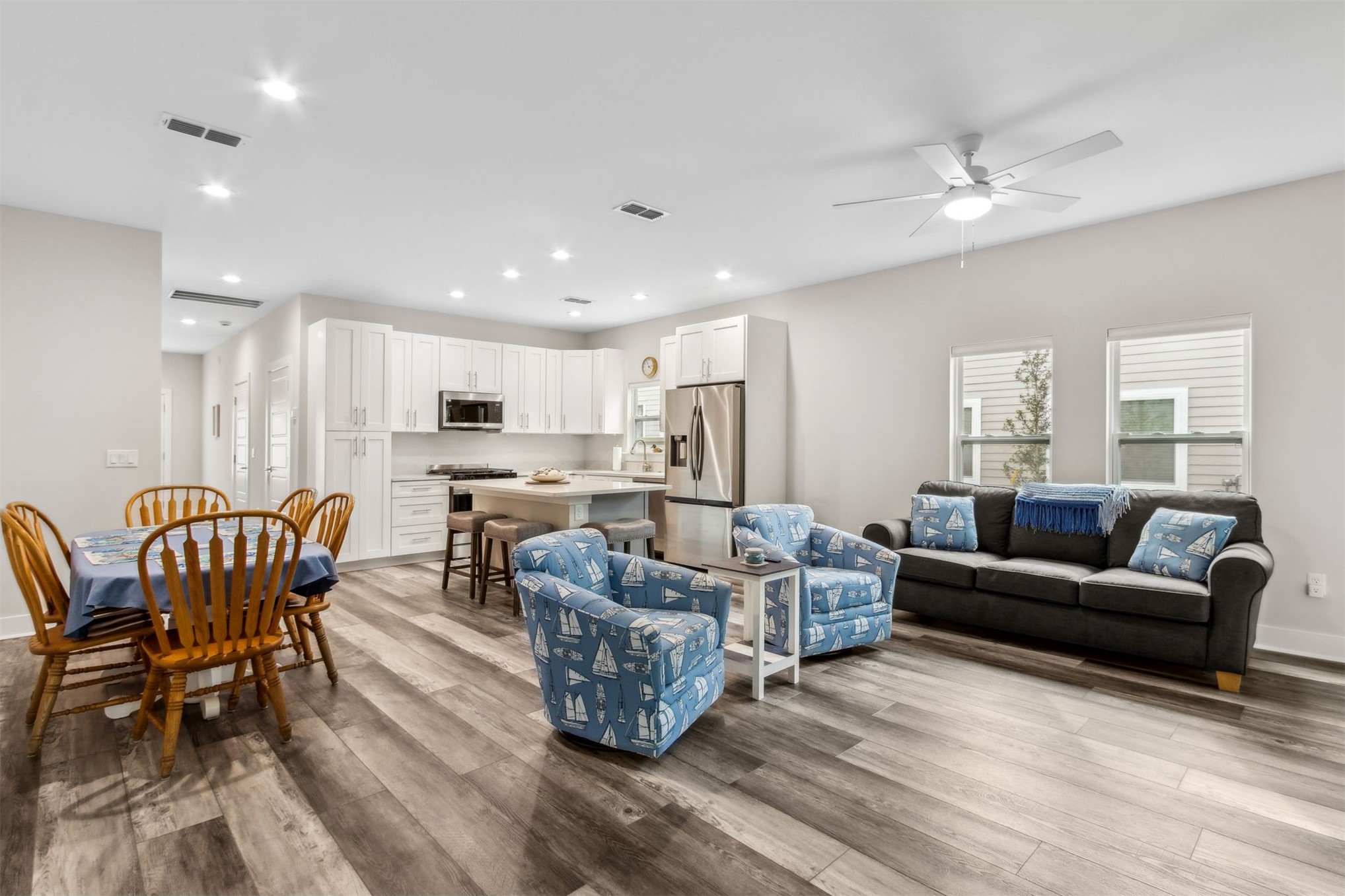 2017 Ryan Road Fernandina Beach, FL 32034 - Photo 6 of 39 a living room kitchen with a couch and a dining table with wooden floor