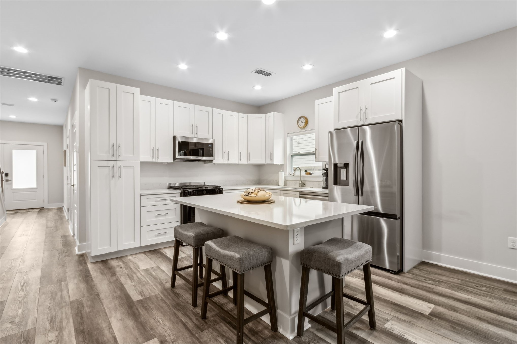 2017 Ryan Road Fernandina Beach, FL 32034 - Photo 8 of 39 a kitchen with stainless steel appliances a refrigerator a stove a sink dishwasher and a refrigerator with wooden floor
