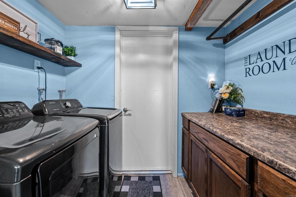 772 Barsby Street Vista, CA 92084 - Photo 14 of 28 a kitchen with a sink a stove and cabinets