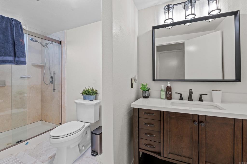 772 Barsby Street Vista, CA 92084 - Photo 16 of 28 a bathroom with a toilet sink and shower
