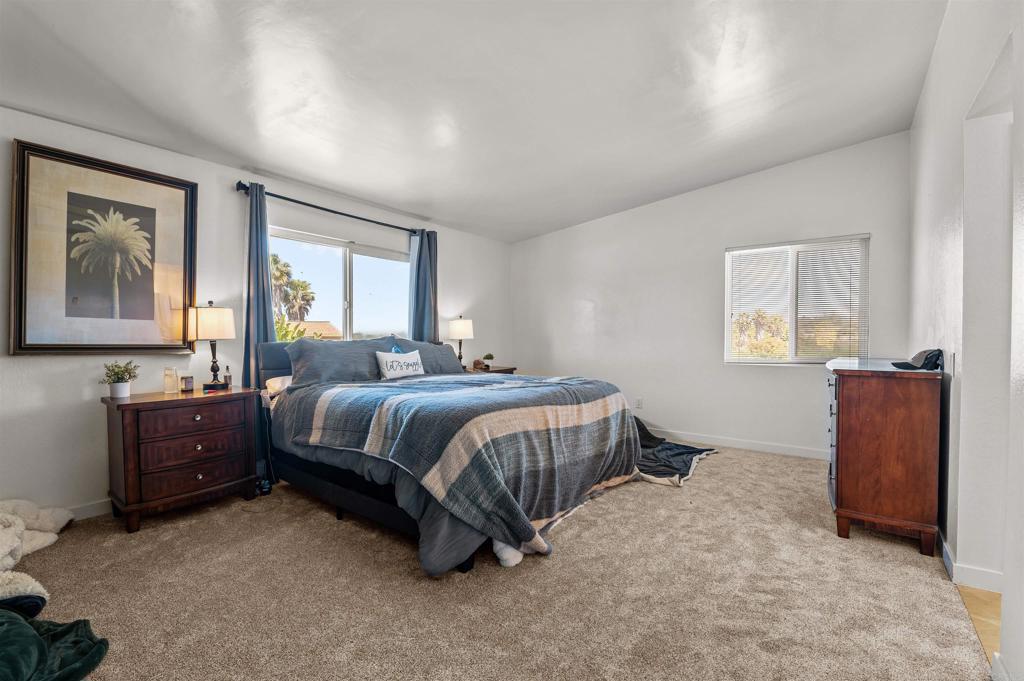 772 Barsby Street Vista, CA 92084 - Photo 18 of 28 a spacious bedroom with a bed and a window