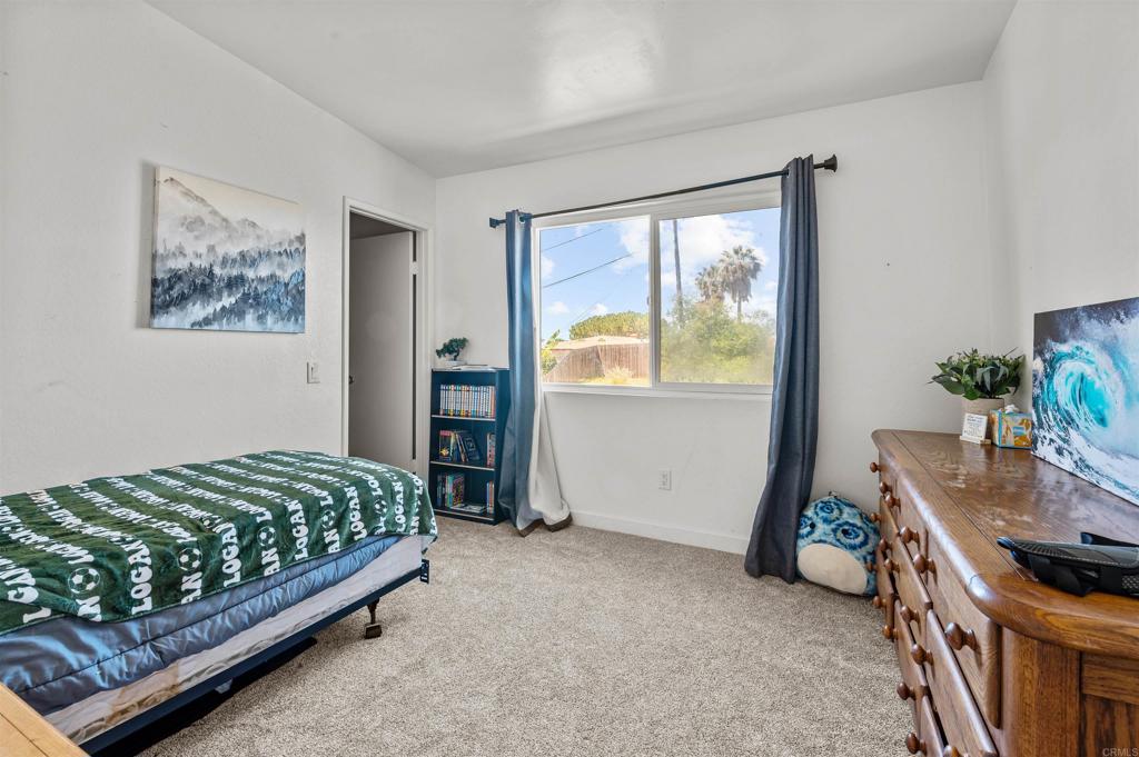772 Barsby Street Vista, CA 92084 - Photo 20 of 28 a bedroom with a bed and a window