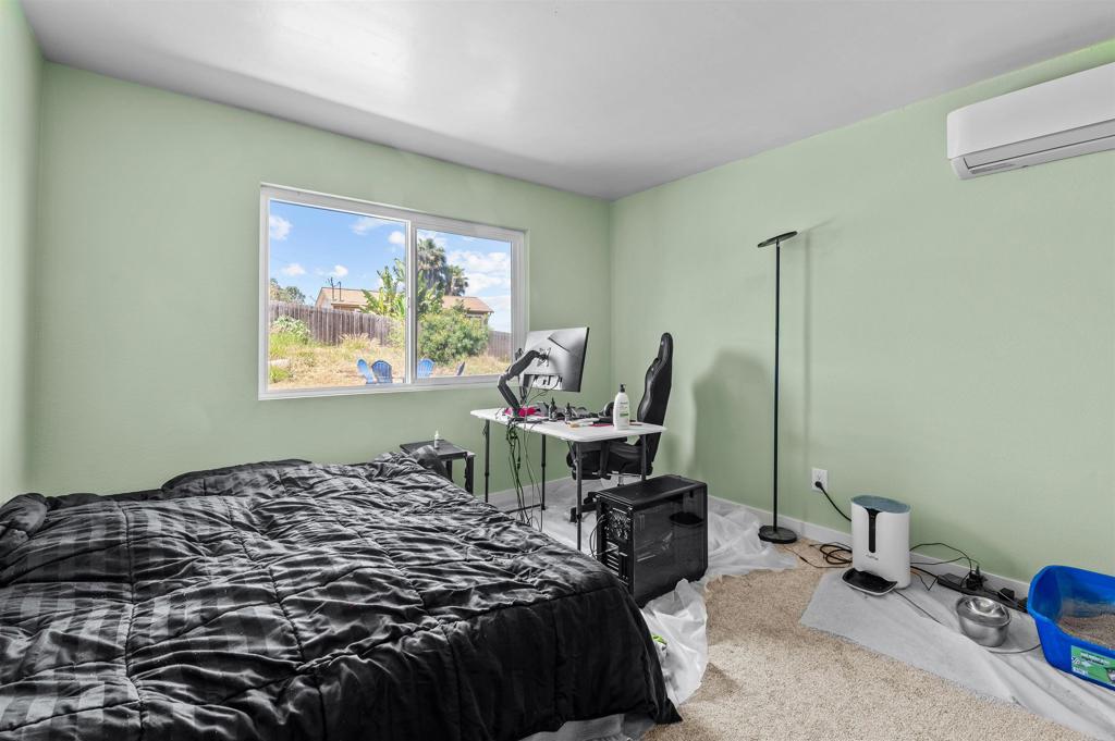 772 Barsby Street Vista, CA 92084 - Photo 21 of 28 a bedroom with a bed and wooden floor