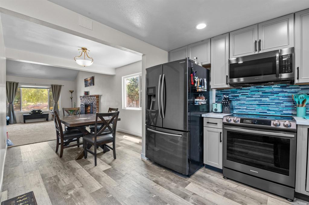 772 Barsby Street Vista, CA 92084 - Photo 10 of 28 a kitchen with stainless steel appliances a stove a refrigerator and a microwave