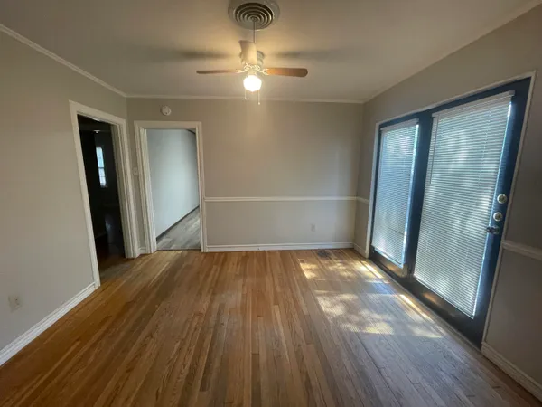 wooden floor in an empty room with a window