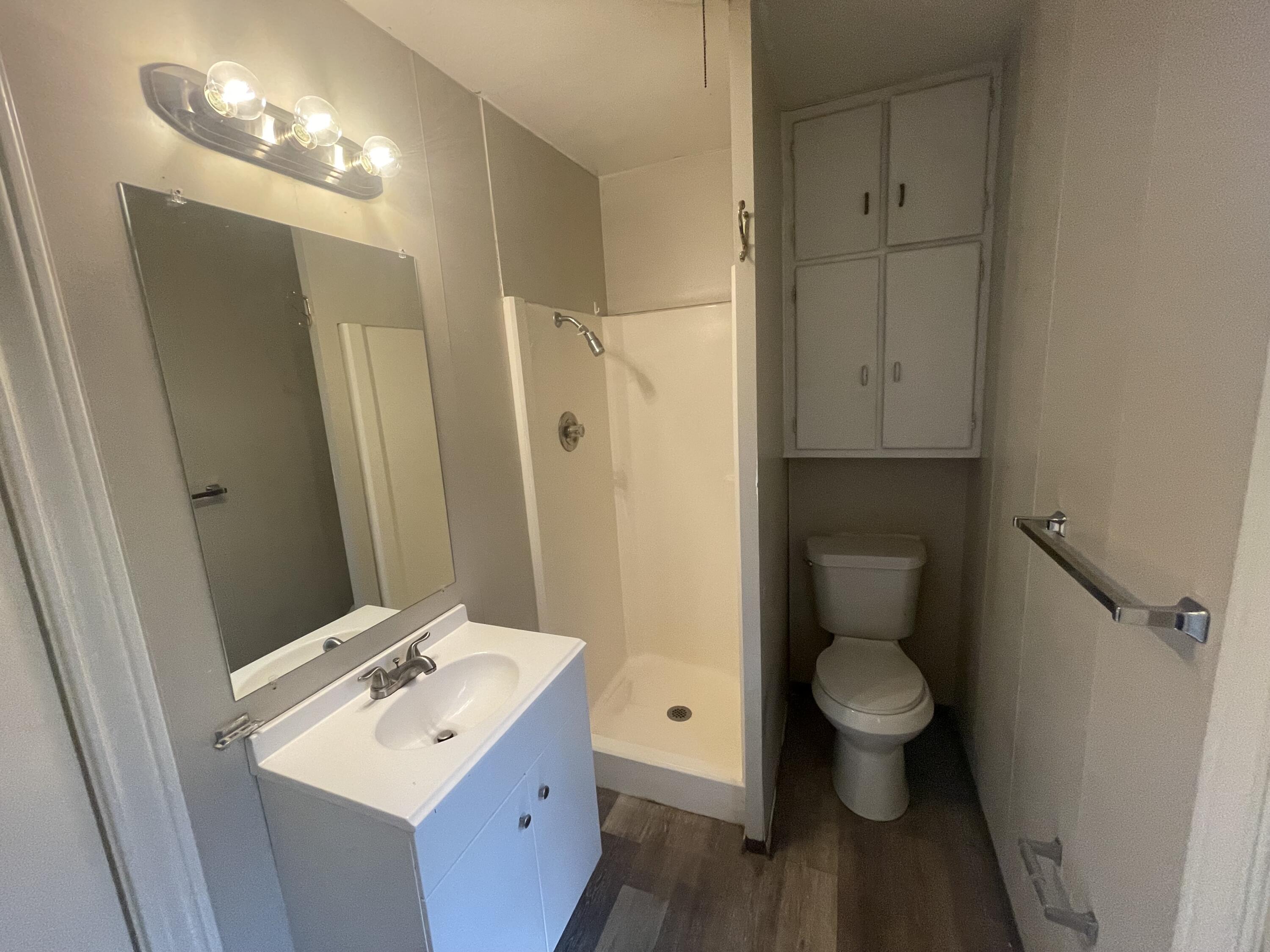 2820 36th Street Lubbock, TX 79413 - Photo 6 of 11 a bathroom with a sink toilet a mirror and vanity