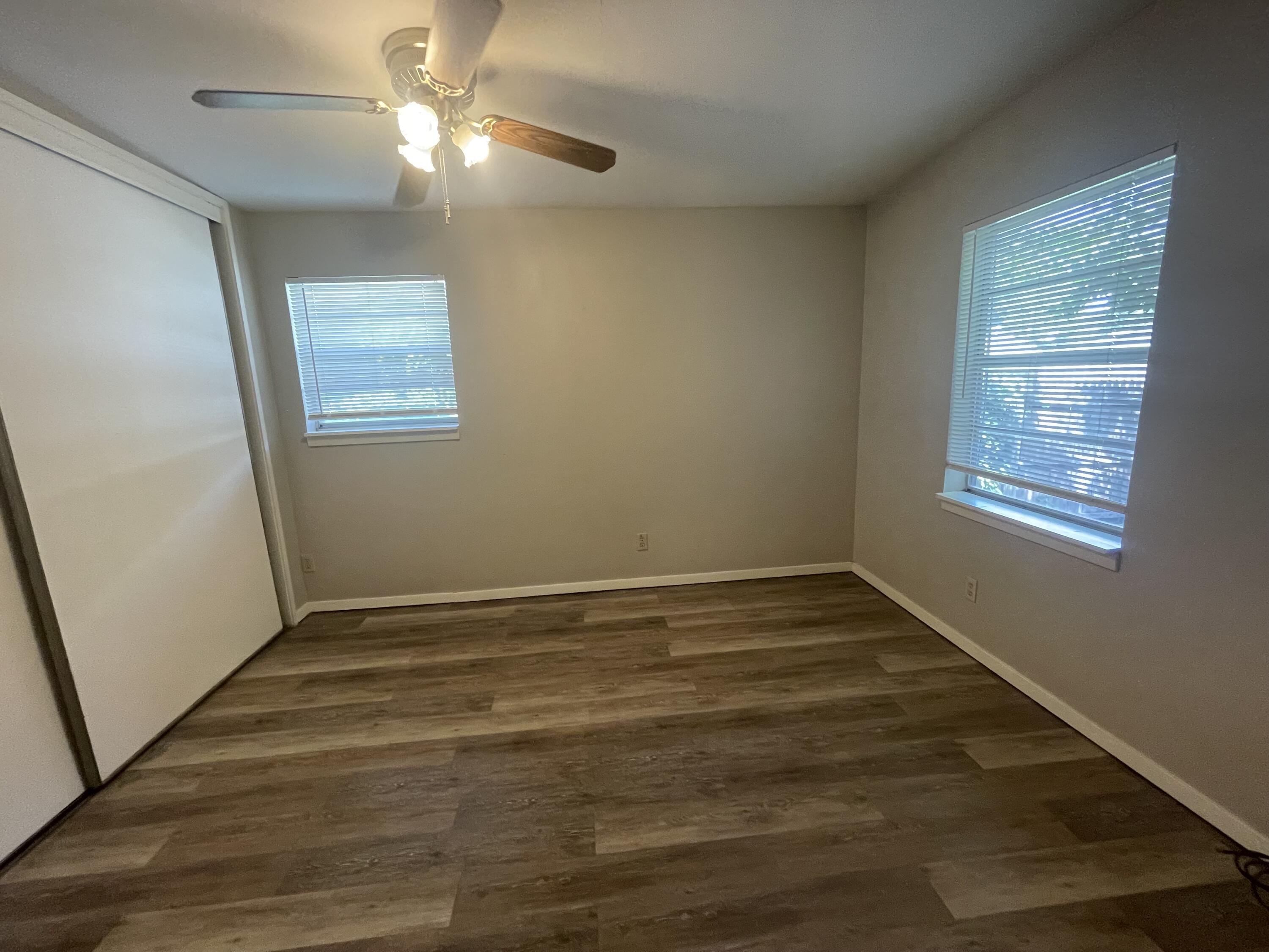 2820 36th Street Lubbock, TX 79413 - Photo 8 of 11 a view of an empty room with wooden floor and a window