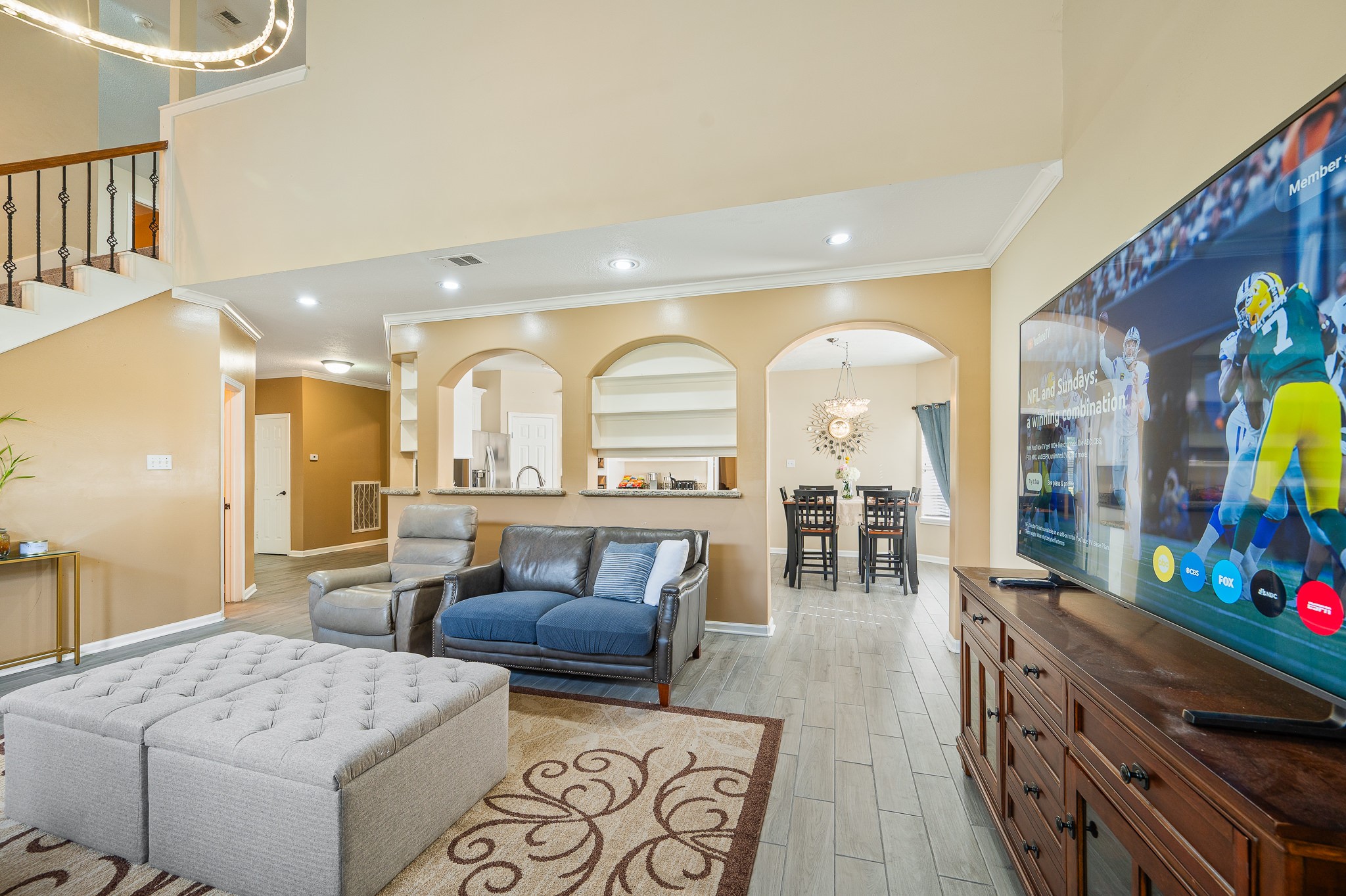 8111 Morningbrook Court Spring, TX 77379 - Photo 16 of 46 a living room with furniture a flat screen tv and a floor to ceiling window