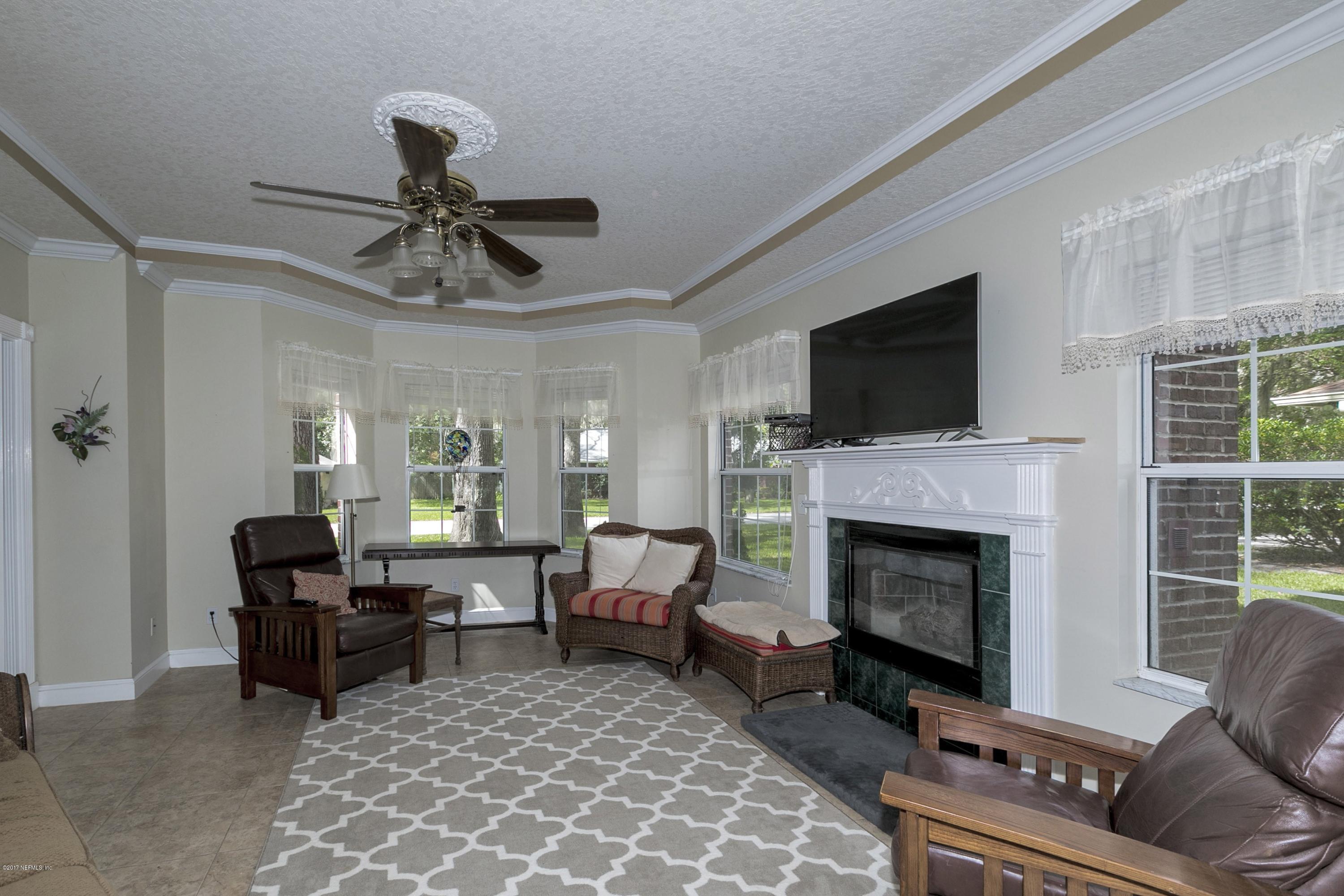 3301 Turtle Creek Road St. Augustine, FL 32086 - Photo 5 of 26 a living room with furniture and a fireplace