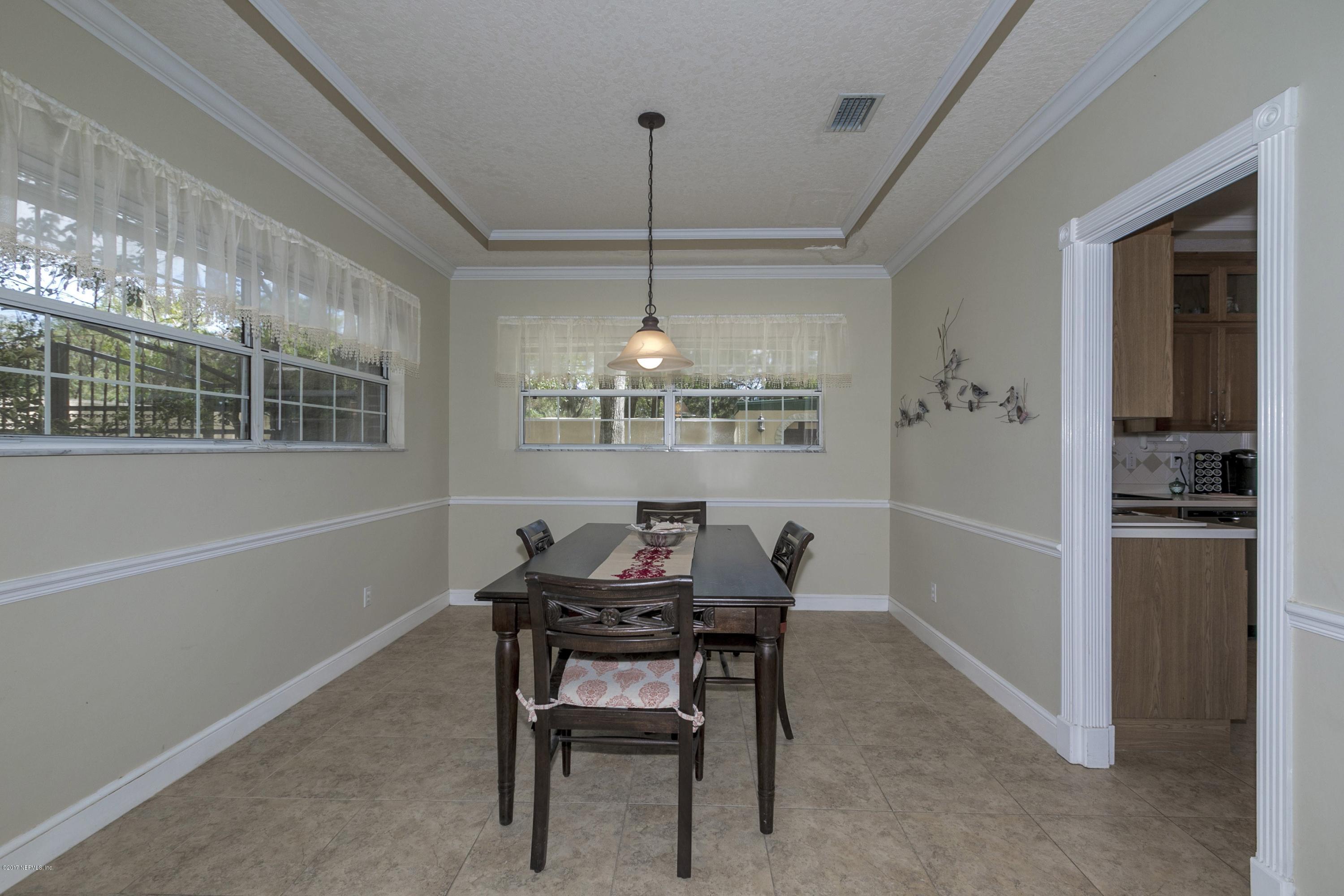 3301 Turtle Creek Road St. Augustine, FL 32086 - Photo 6 of 26 a dining room with furniture a chandelier and window