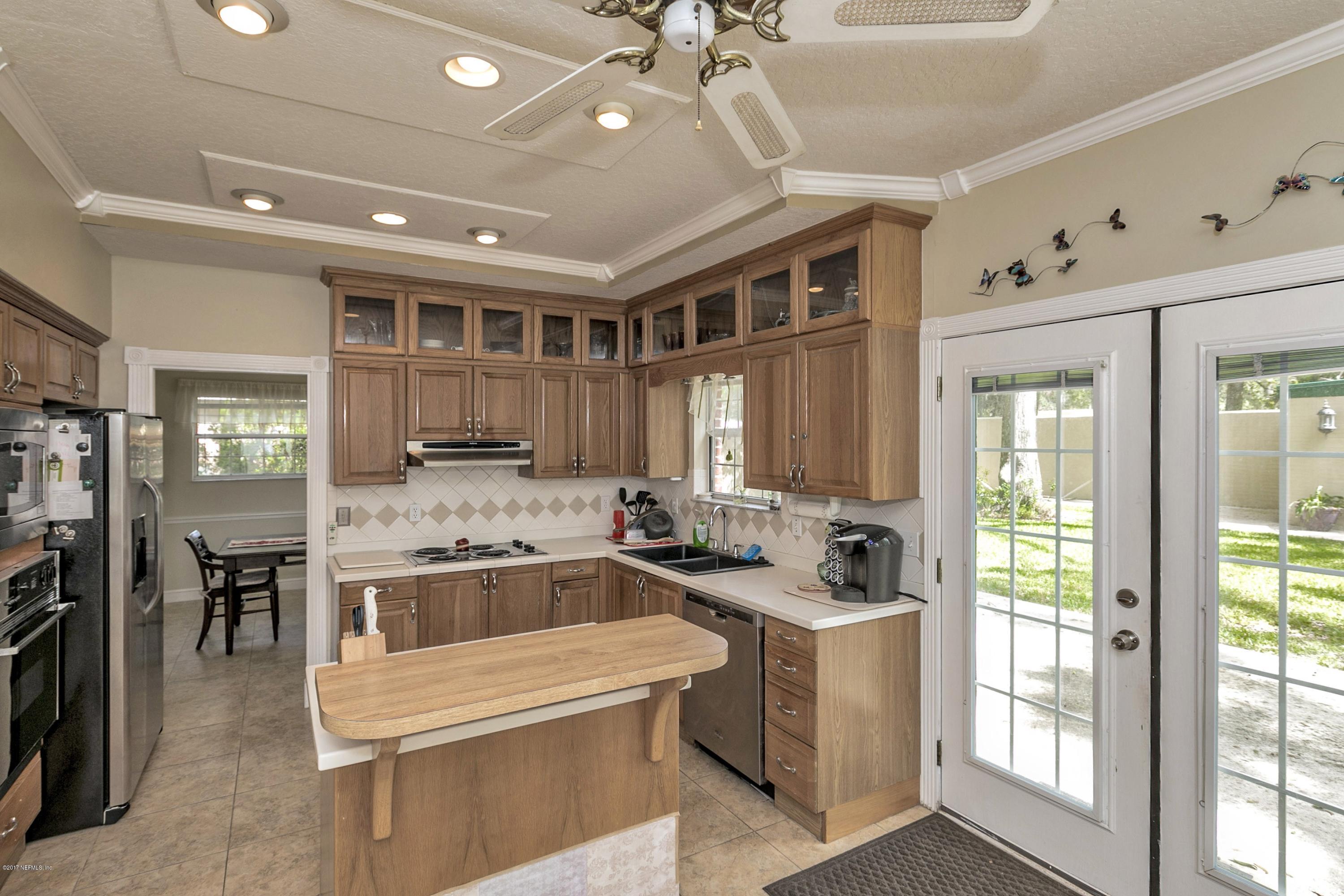 3301 Turtle Creek Road St. Augustine, FL 32086 - Photo 7 of 26 a kitchen that has a lot of cabinets in it and wooden floors