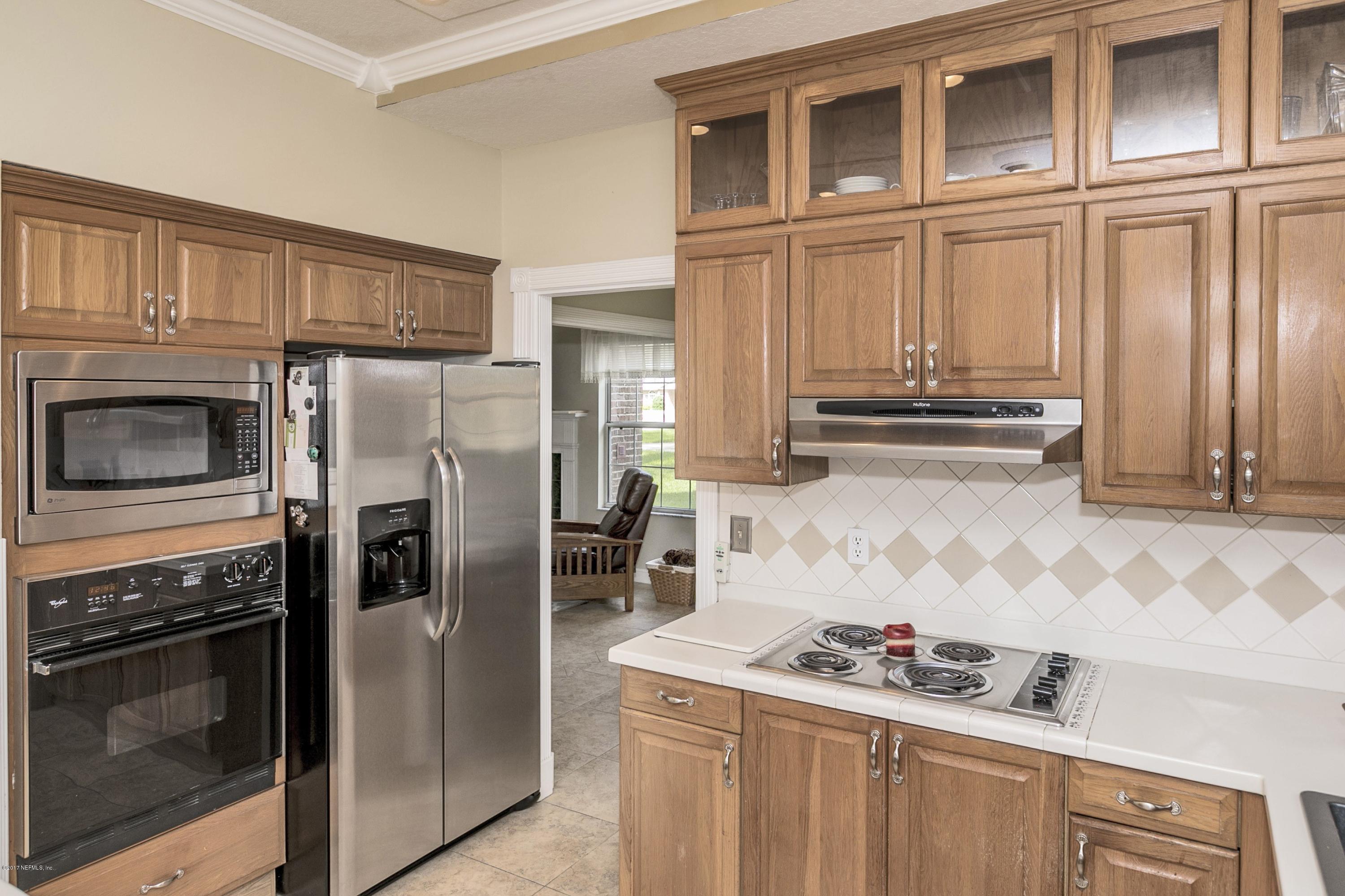 3301 Turtle Creek Road St. Augustine, FL 32086 - Photo 8 of 26 a kitchen with stainless steel appliances granite countertop a stove and a refrigerator