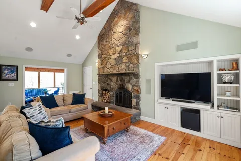 a living room with furniture and a floor to ceiling window