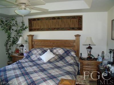 5371 Buckingham Road Fort Myers, FL 33905 - Photo 8 of 10 a bedroom with a bed and a dresser
