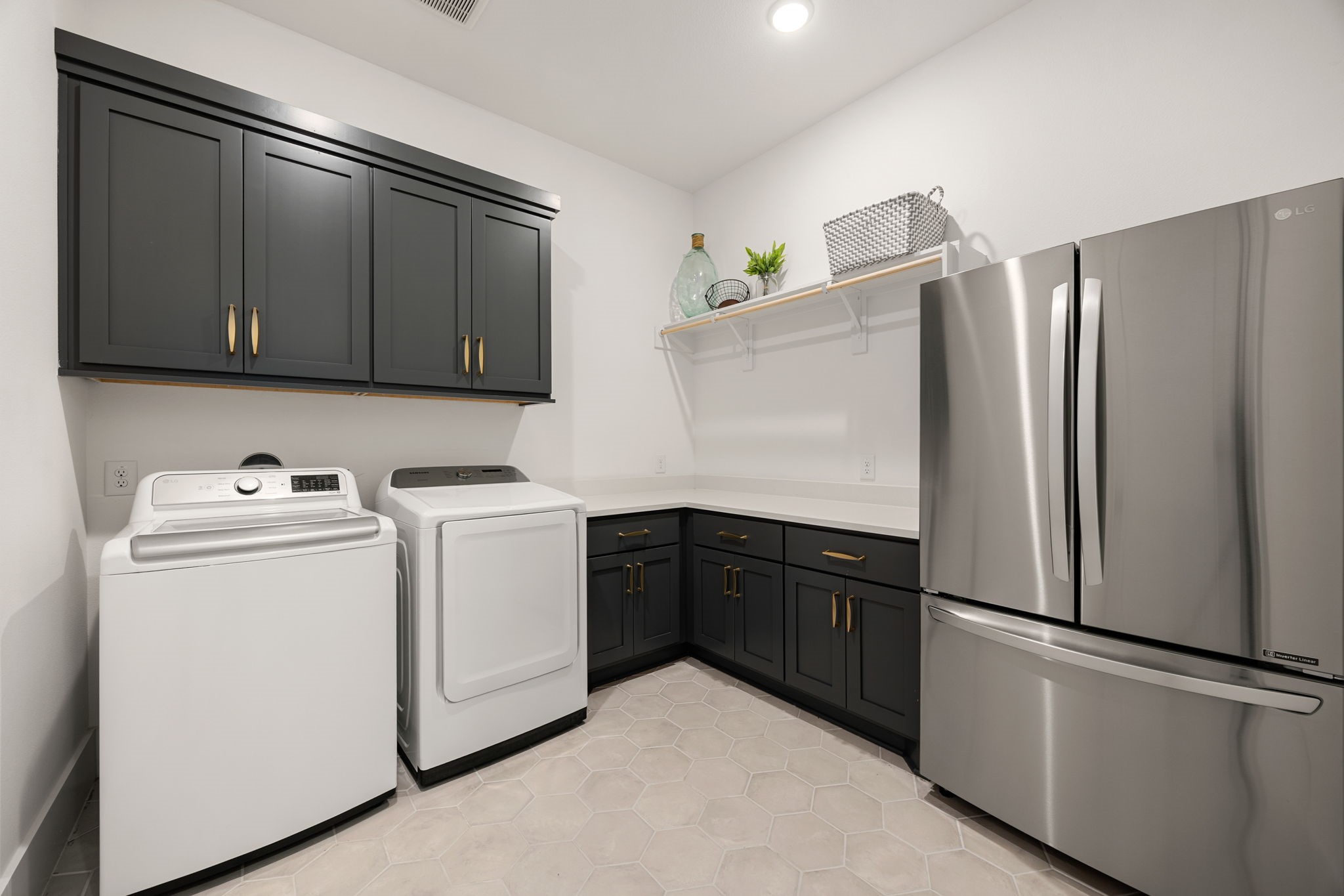 27903 Indigo Ridge Drive Fulshear, TX 77441 - Photo 28 of 50 Large laundry and utility room with extensive cabinetry, generous counter space, and additional refrigerator storage for everyday convenience.