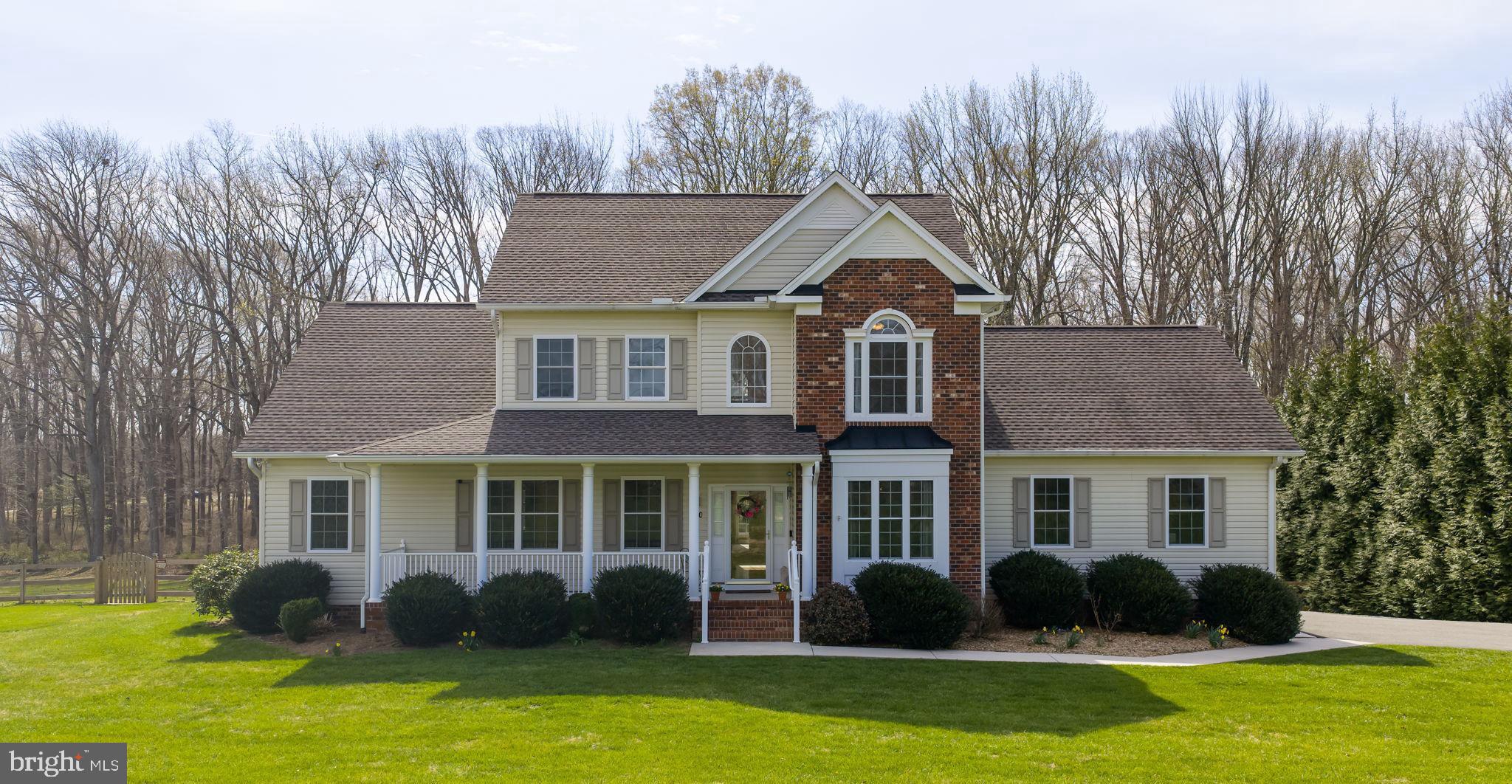 a front view of a house with a garden and plants
