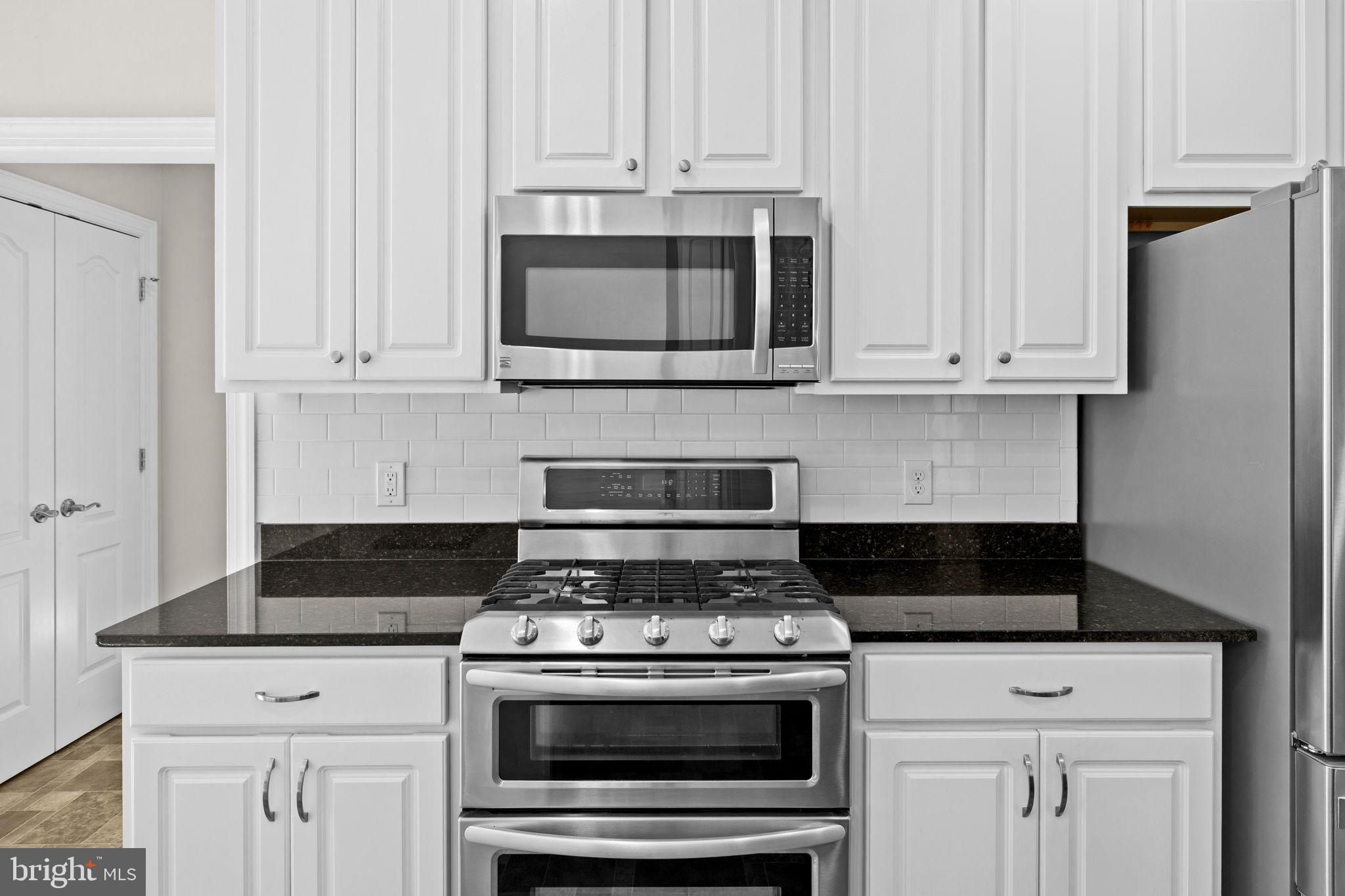 240 Poplar Road Fredericksburg, VA 22406 - Photo 14 of 77 a stove top oven sitting inside of a kitchen
