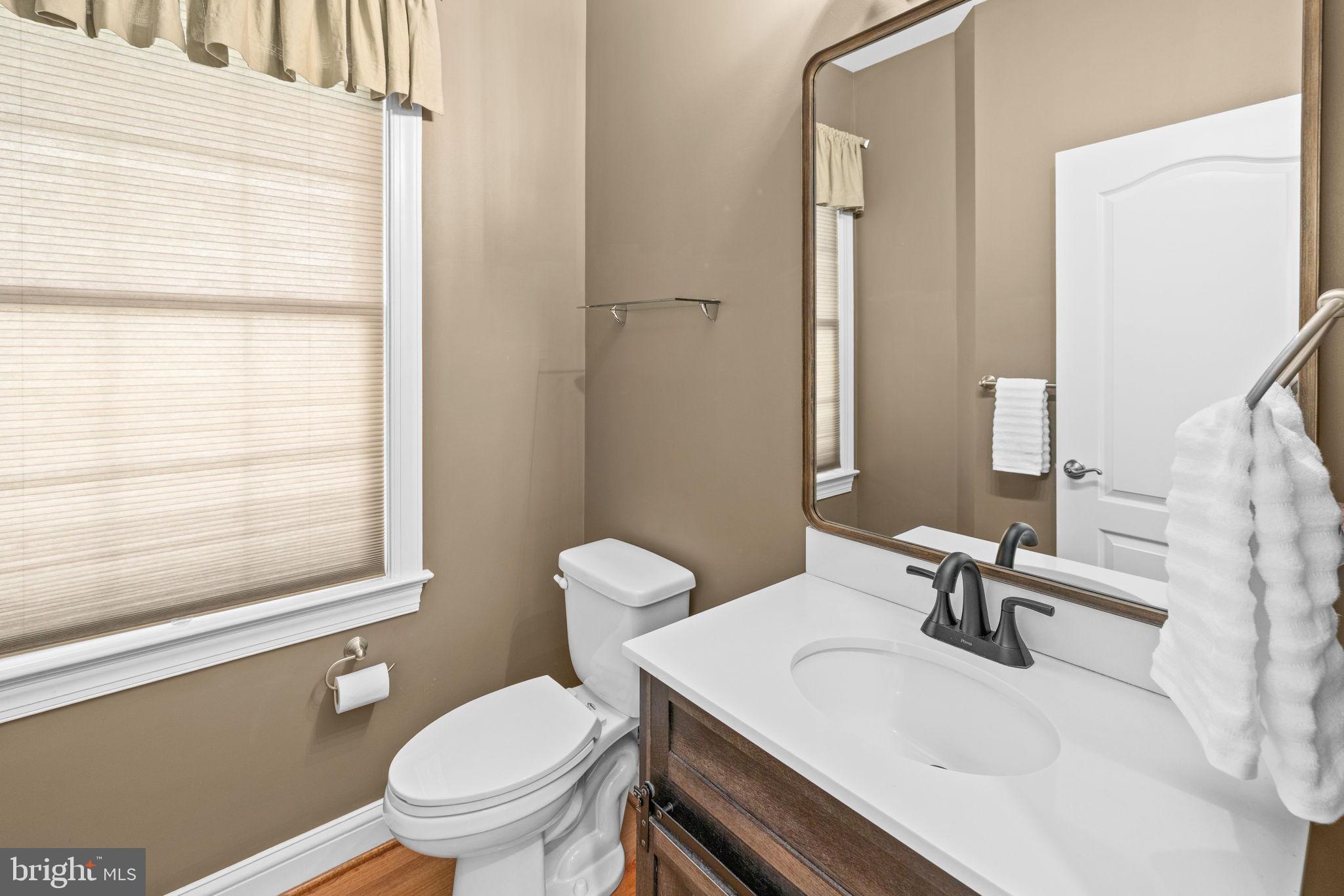 240 Poplar Road Fredericksburg, VA 22406 - Photo 32 of 77 a bathroom with a sink toilet a mirror and shower