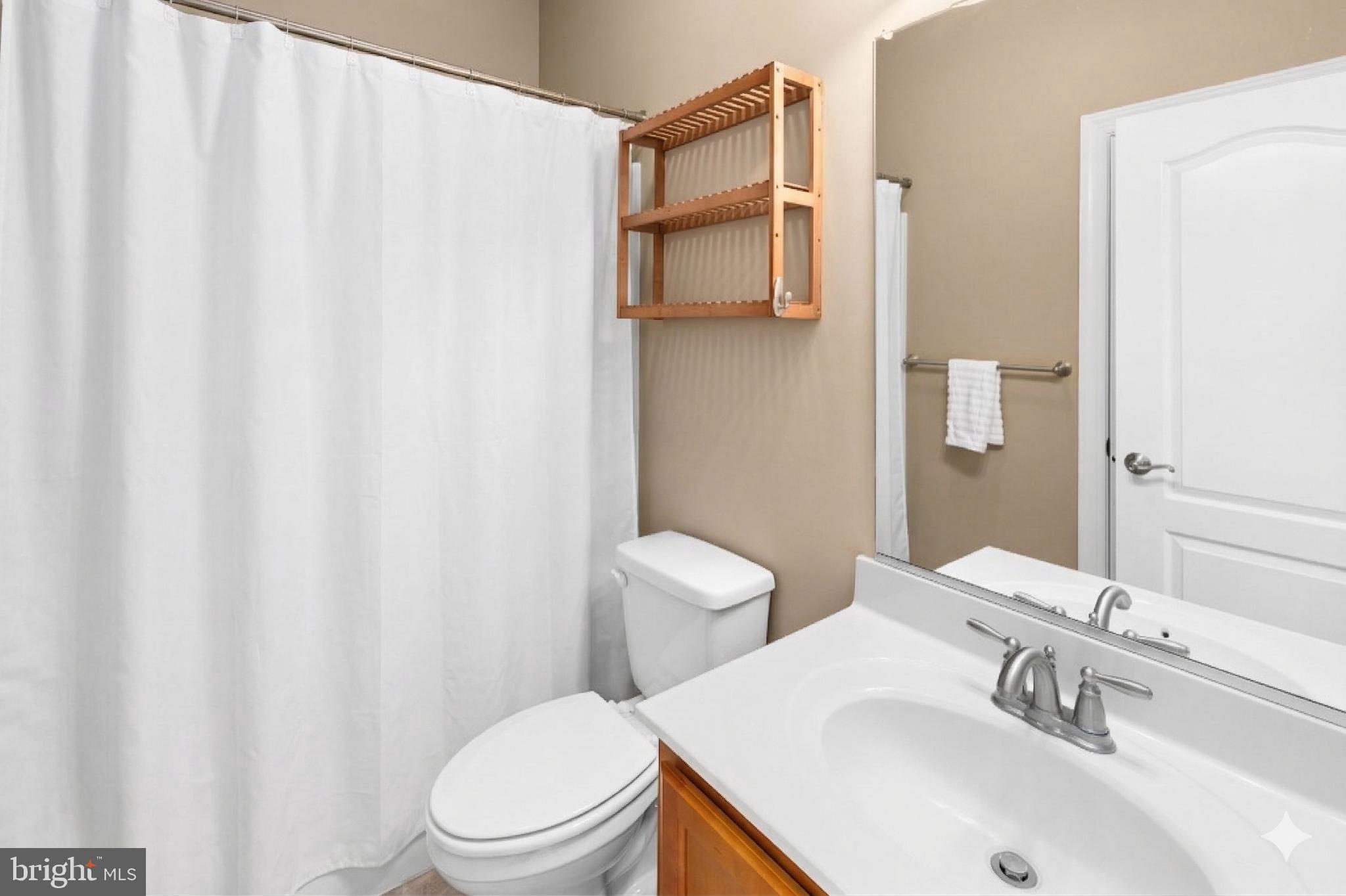 240 Poplar Road Fredericksburg, VA 22406 - Photo 41 of 77 a bathroom with a sink a toilet and shower curtain