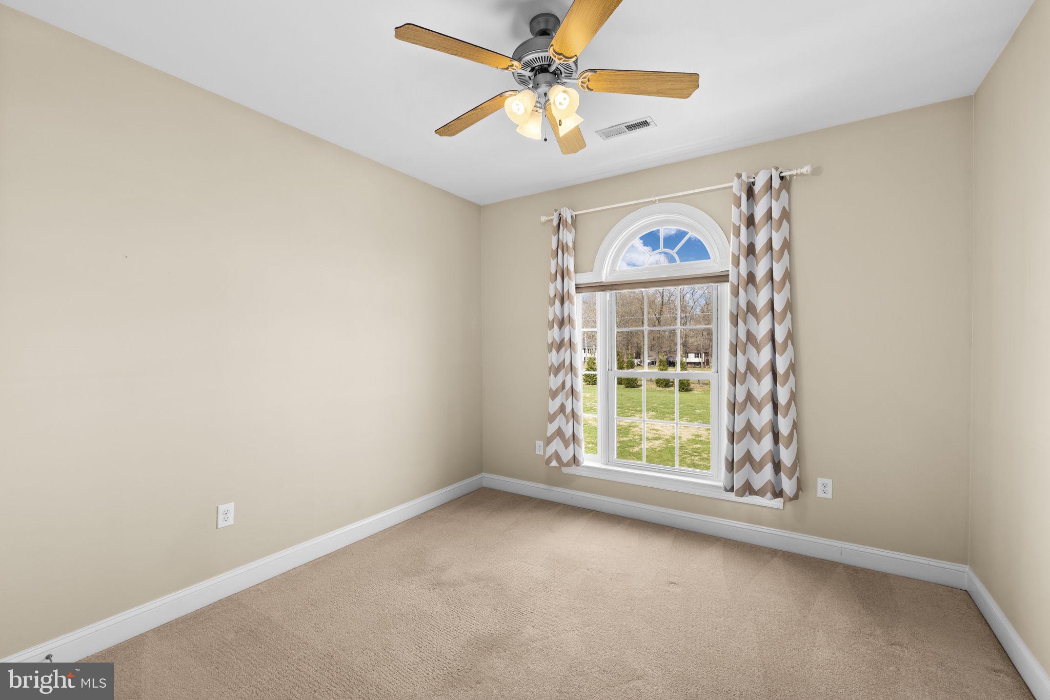240 Poplar Road Fredericksburg, VA 22406 - Photo 42 of 77 an empty room with windows and a ceiling fan