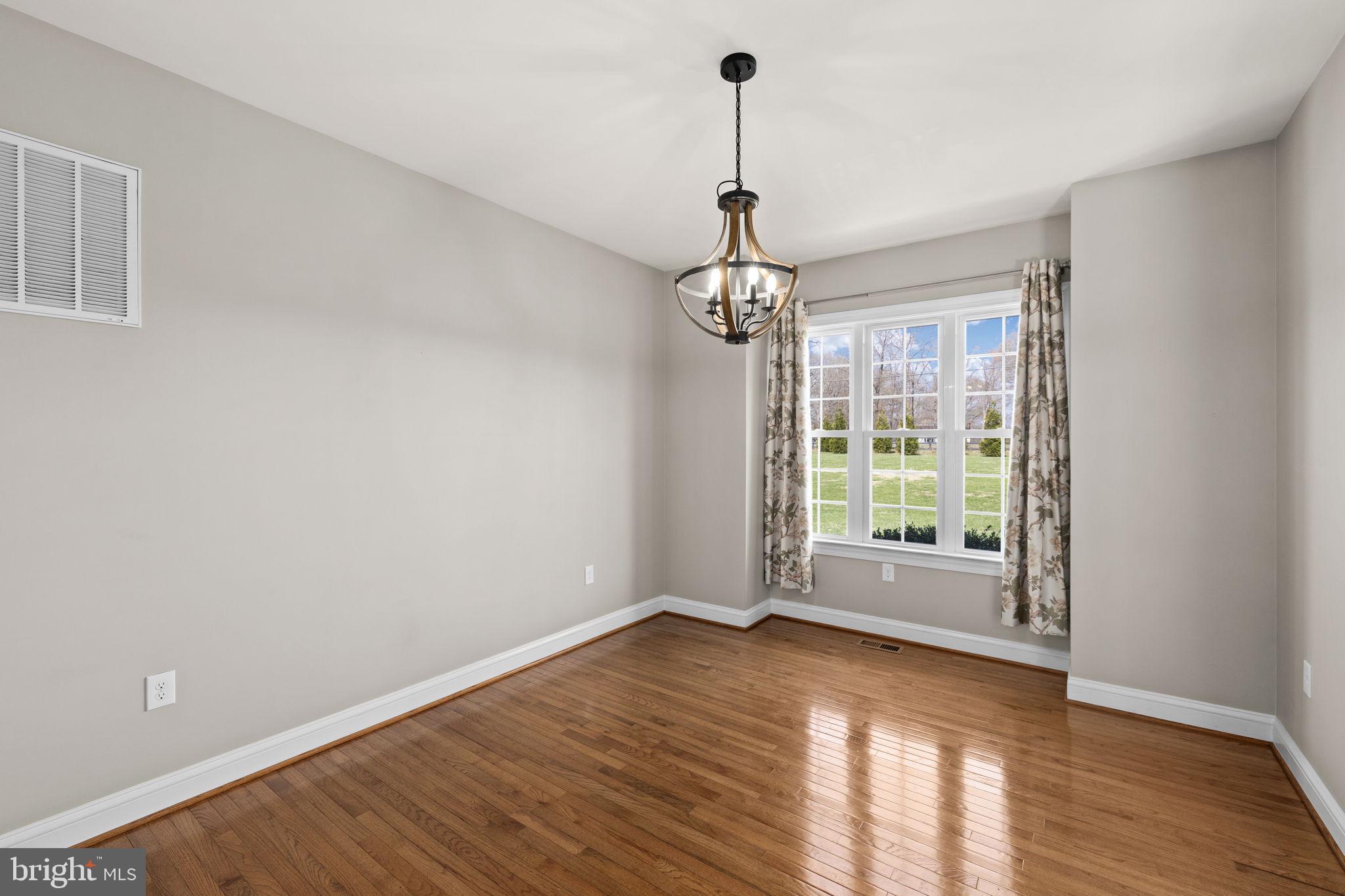 240 Poplar Road Fredericksburg, VA 22406 - Photo 9 of 77 a view of an empty room with wooden floor and a window