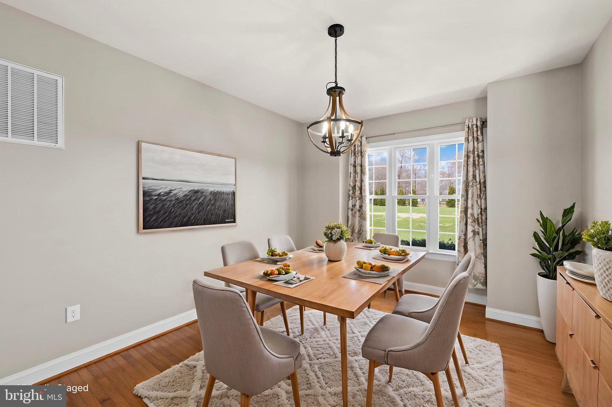 240 Poplar Road Fredericksburg, VA 22406 - Photo 10 of 77 a dining room with furniture a chandelier and wooden floor