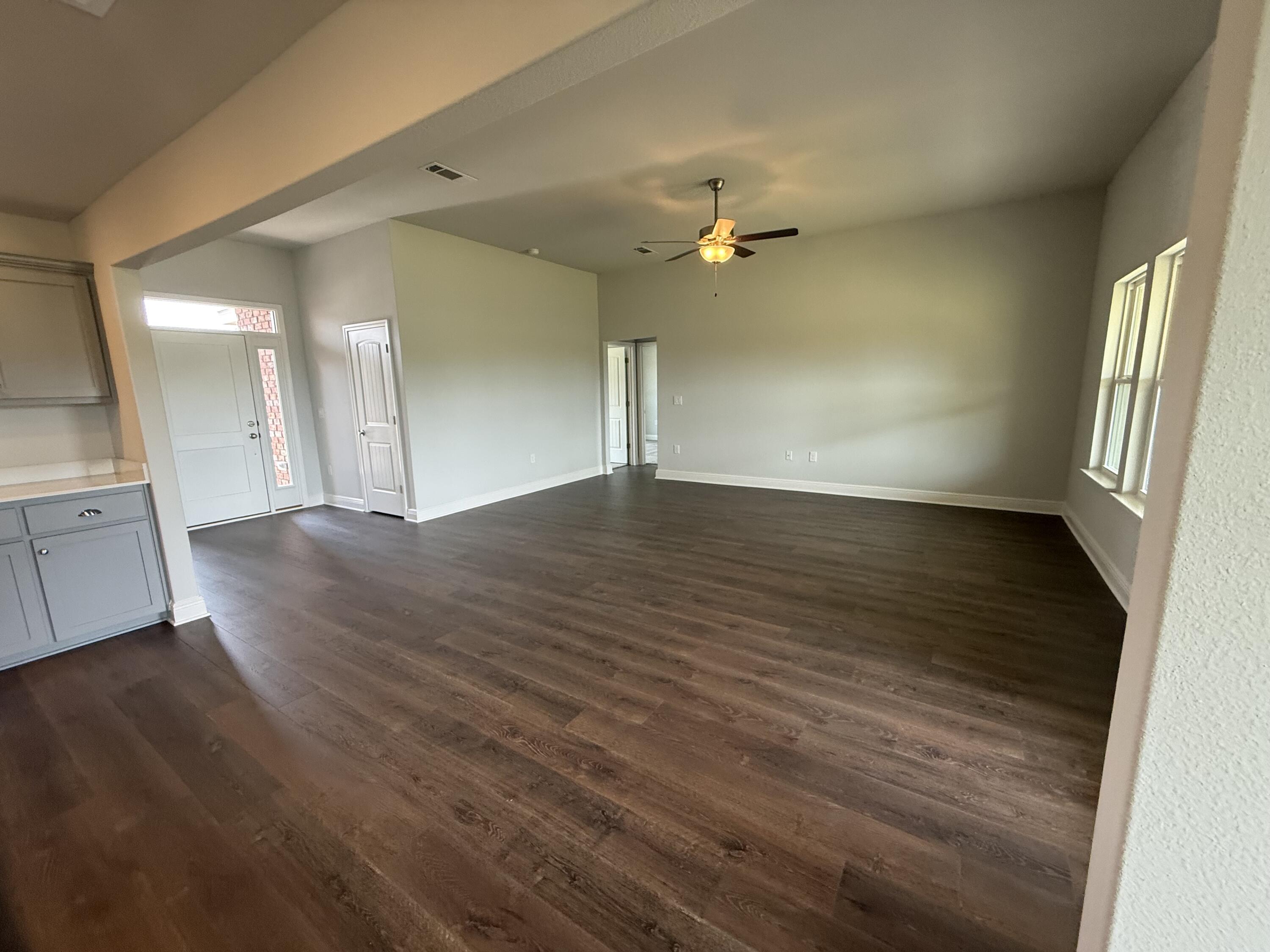 6004 Crocket Cove Crestview, FL 32539 - Photo 7 of 24 wooden floor in an empty room with a window