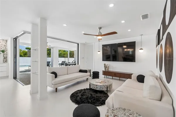 a view of a house with backyard porch and sitting area