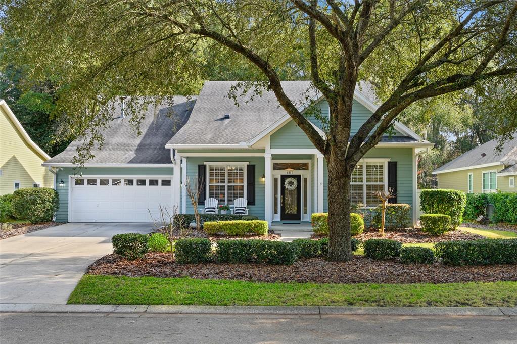 a front view of a house with a garden