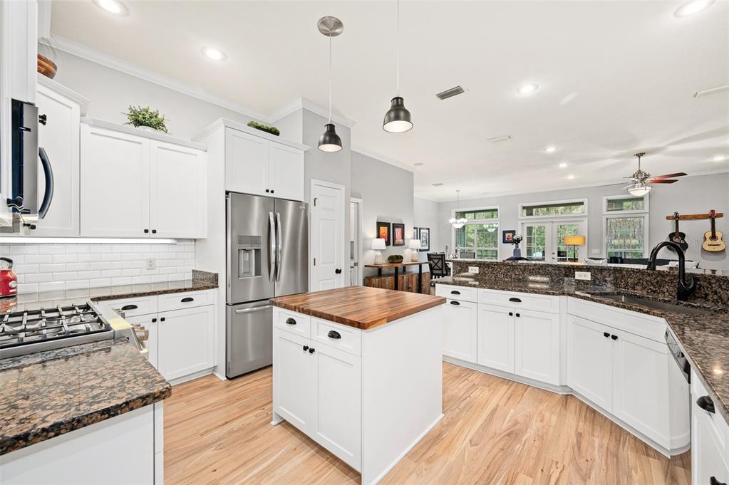 6377 Southwest 88th Terrace Gainesville, FL 32608 - Photo 14 of 37 a kitchen with stainless steel appliances granite countertop a sink stove and refrigerator