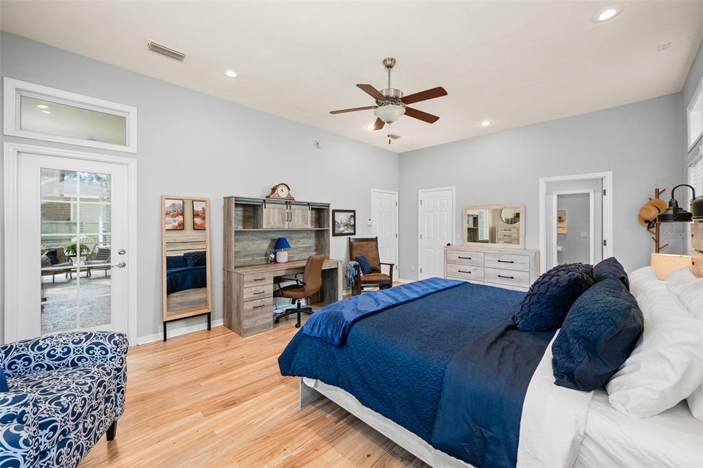 6377 Southwest 88th Terrace Gainesville, FL 32608 - Photo 18 of 37 a bedroom with a large bed and a tv